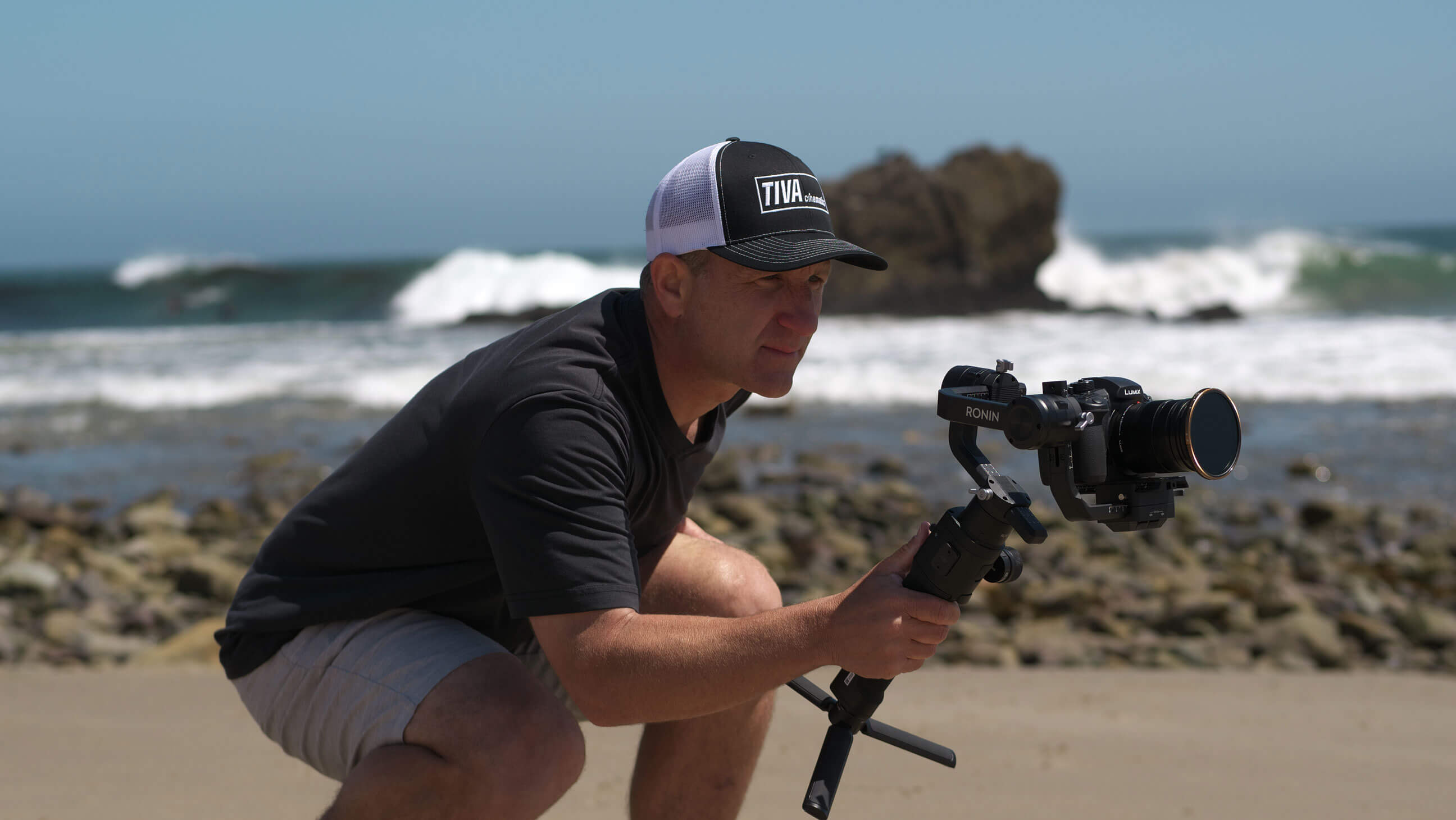 A photographer holding a camera steadily in motion