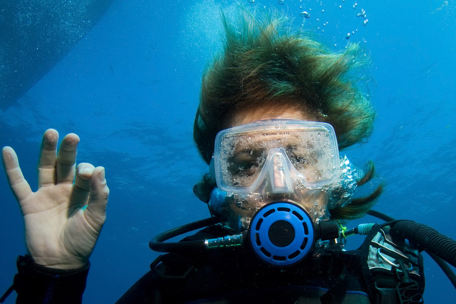 A person scuba diving in clear water